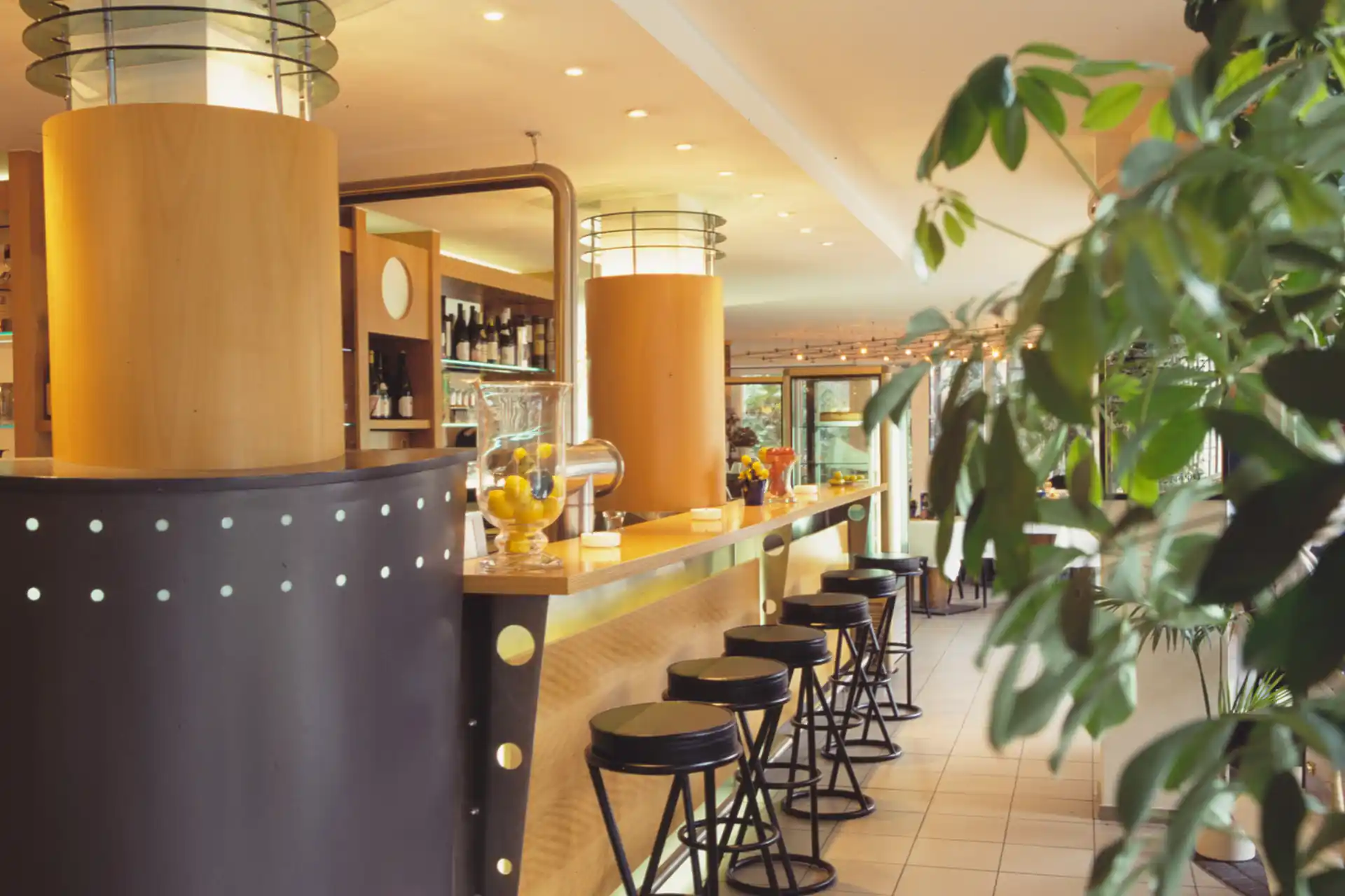 Moderner Barbereich mit langem Tresen, Barhockern und dekorativen Säulen im ACHAT Hotel Suhl