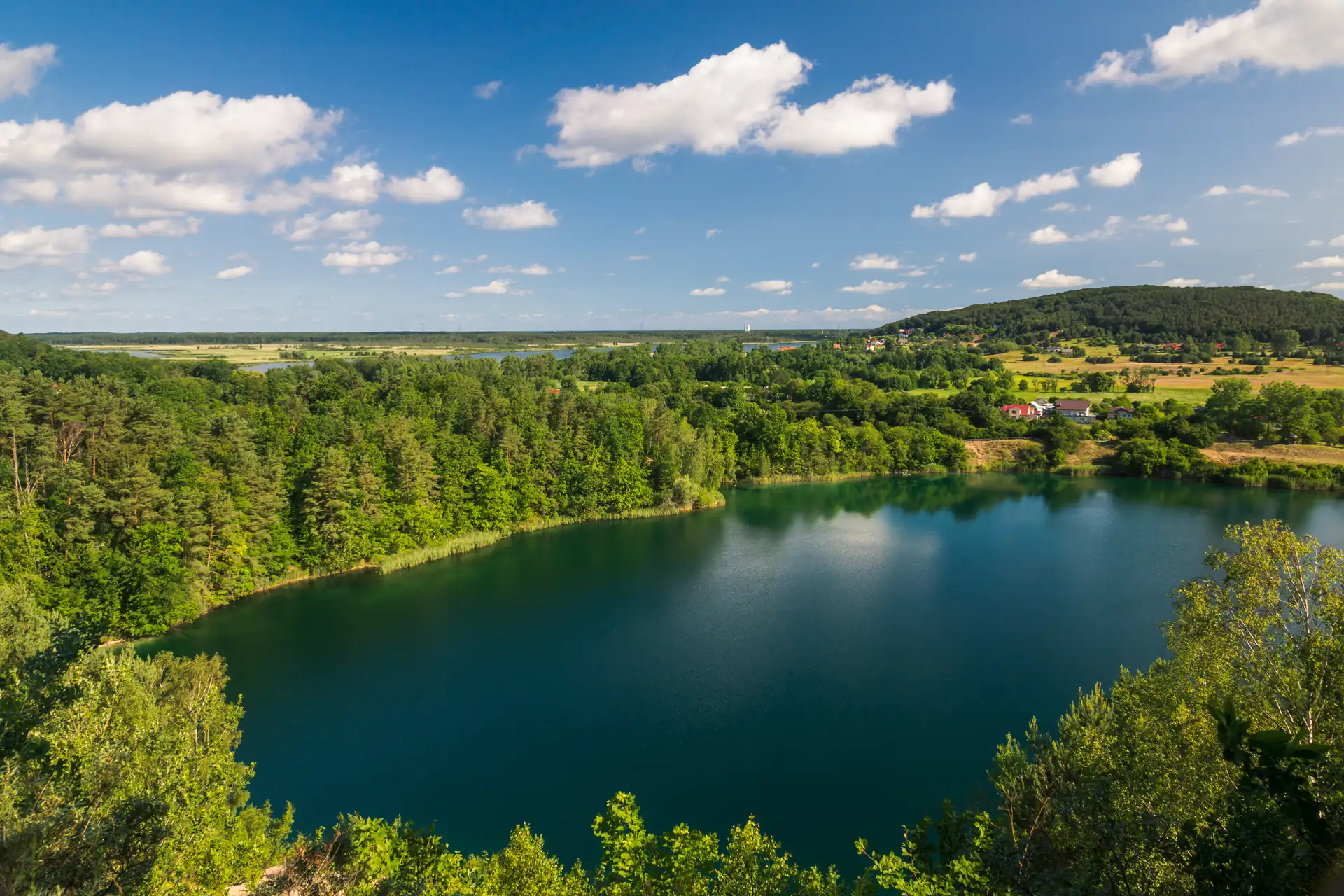 Türkisfarbener See im Wolinski-Nationalpark gesäumt von grünen Wäldern, Polen