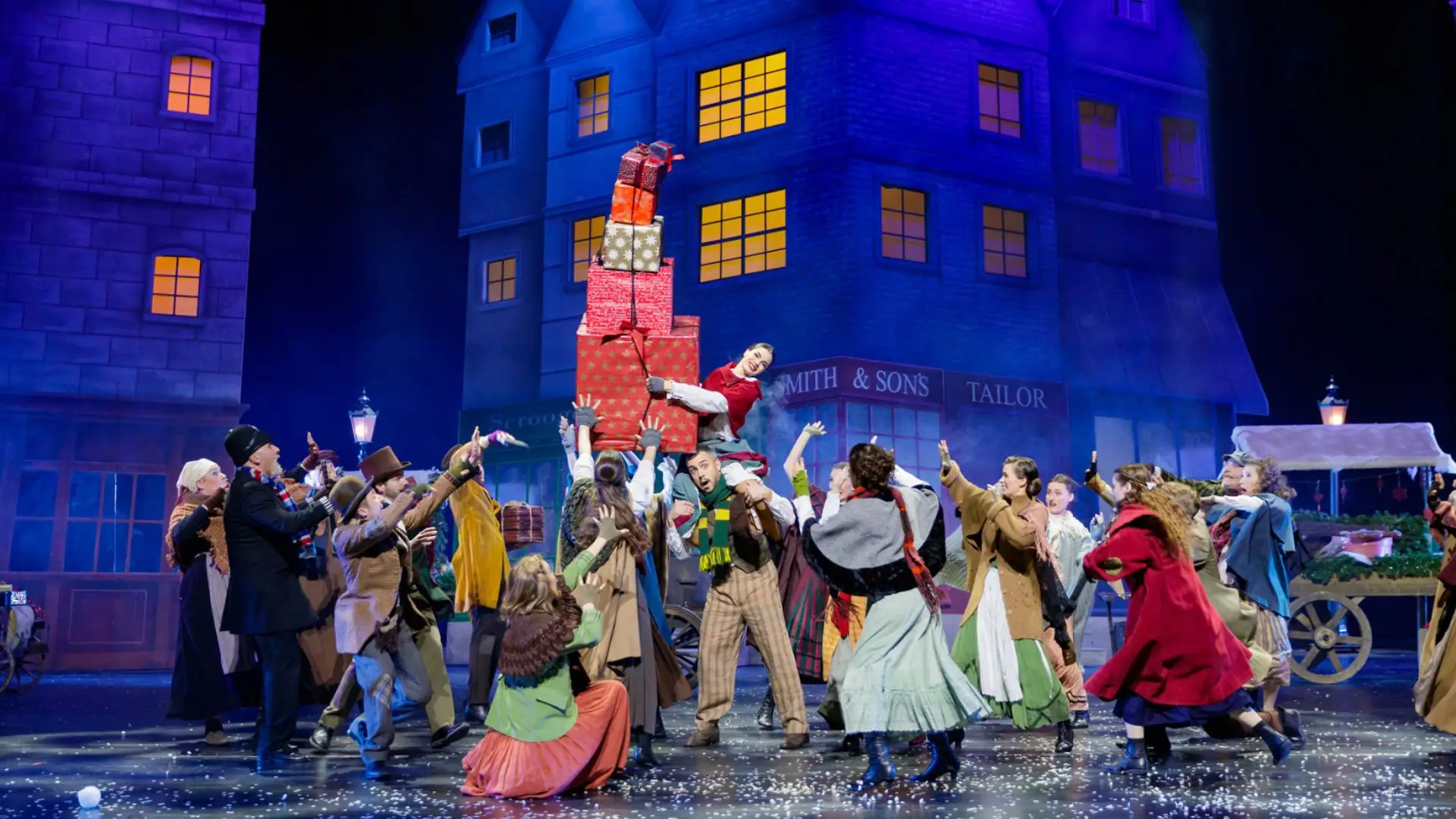 Zweite Szene von Darstellern mit aufeinandergestapelten Geschenken