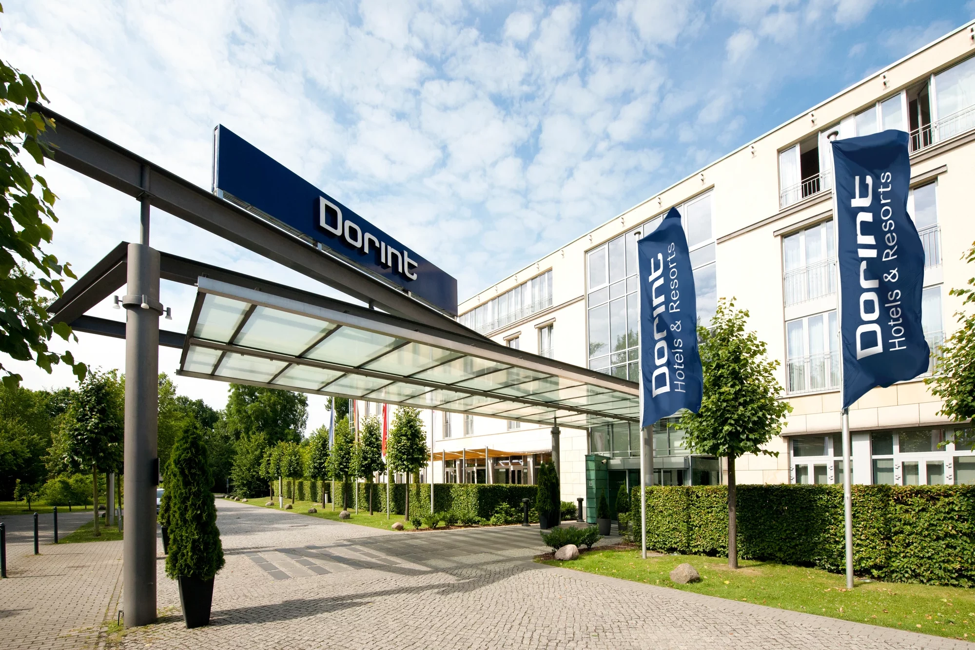Dorint Hotel Potsdam, Eingangsbereich des Hotels mit Überdachung und blauen Dorint-Fahnen