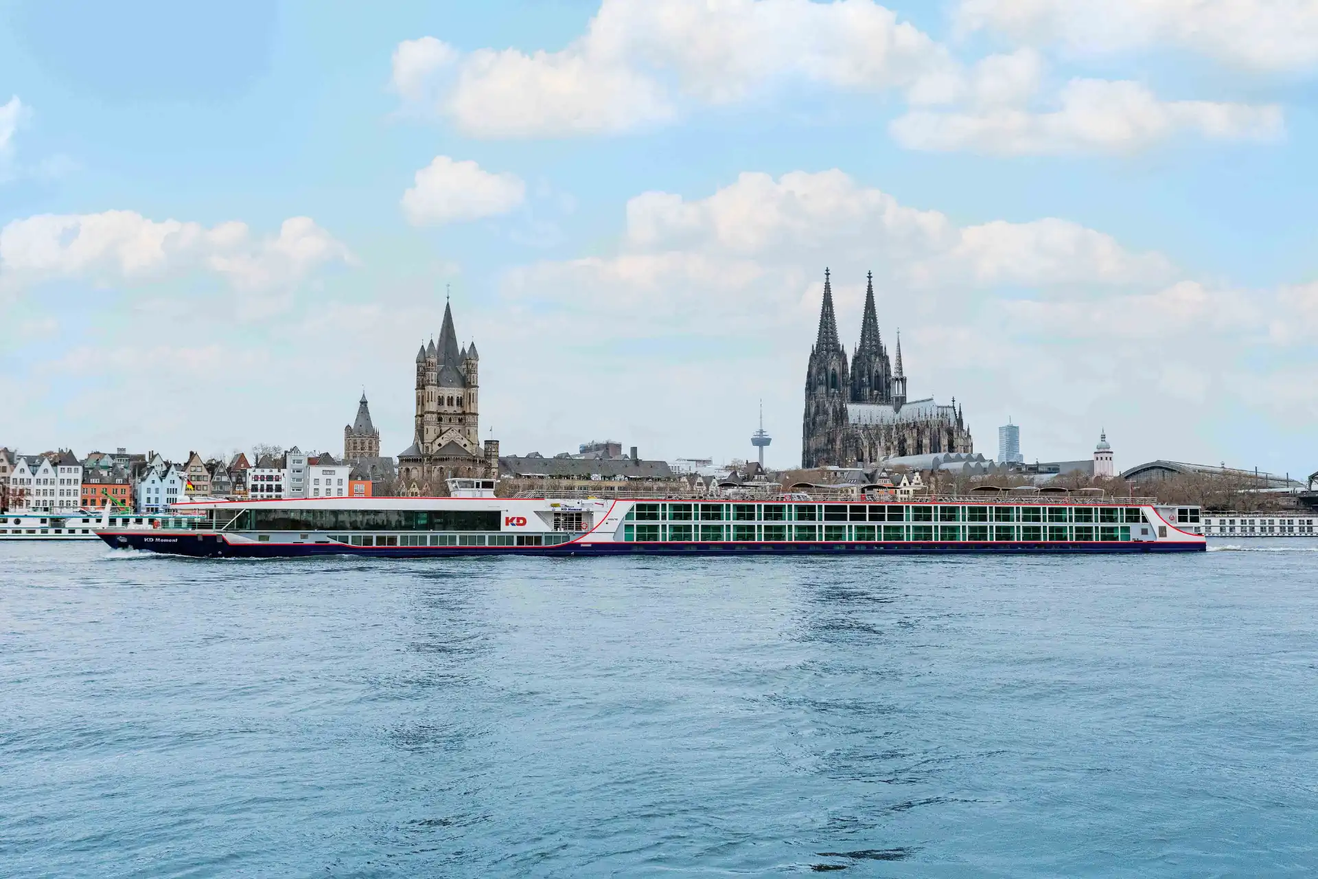 Seitliche Außenansicht des modernen Flusskreuzfahrtschiffs KD Moment, das majestätisch über das Wasser gleitet.