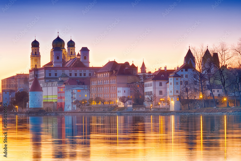 Malerische Stadtansicht von Bayern bei Sonnenuntergang mit reflektierenden Wasserflächen.