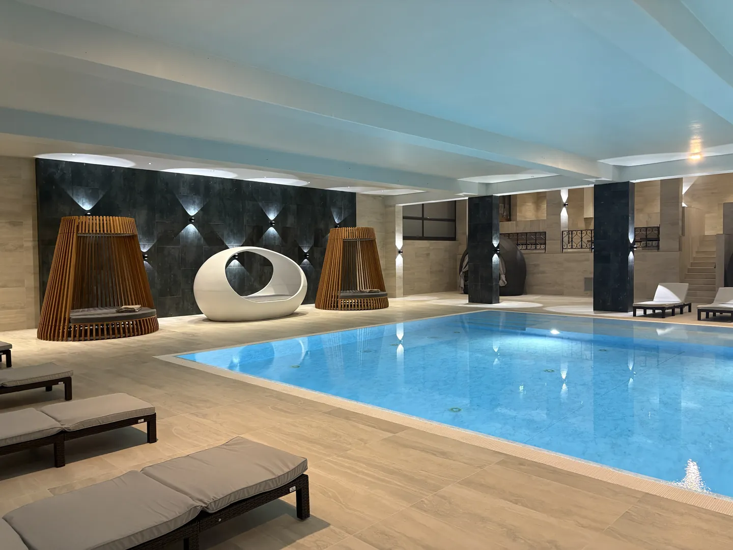 Innenpool mit Liegen und modernem Design