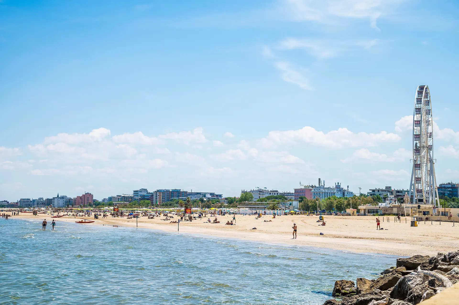 Strand und Hafen von Rimini mit Riesenrad und Badegästen an der Adria