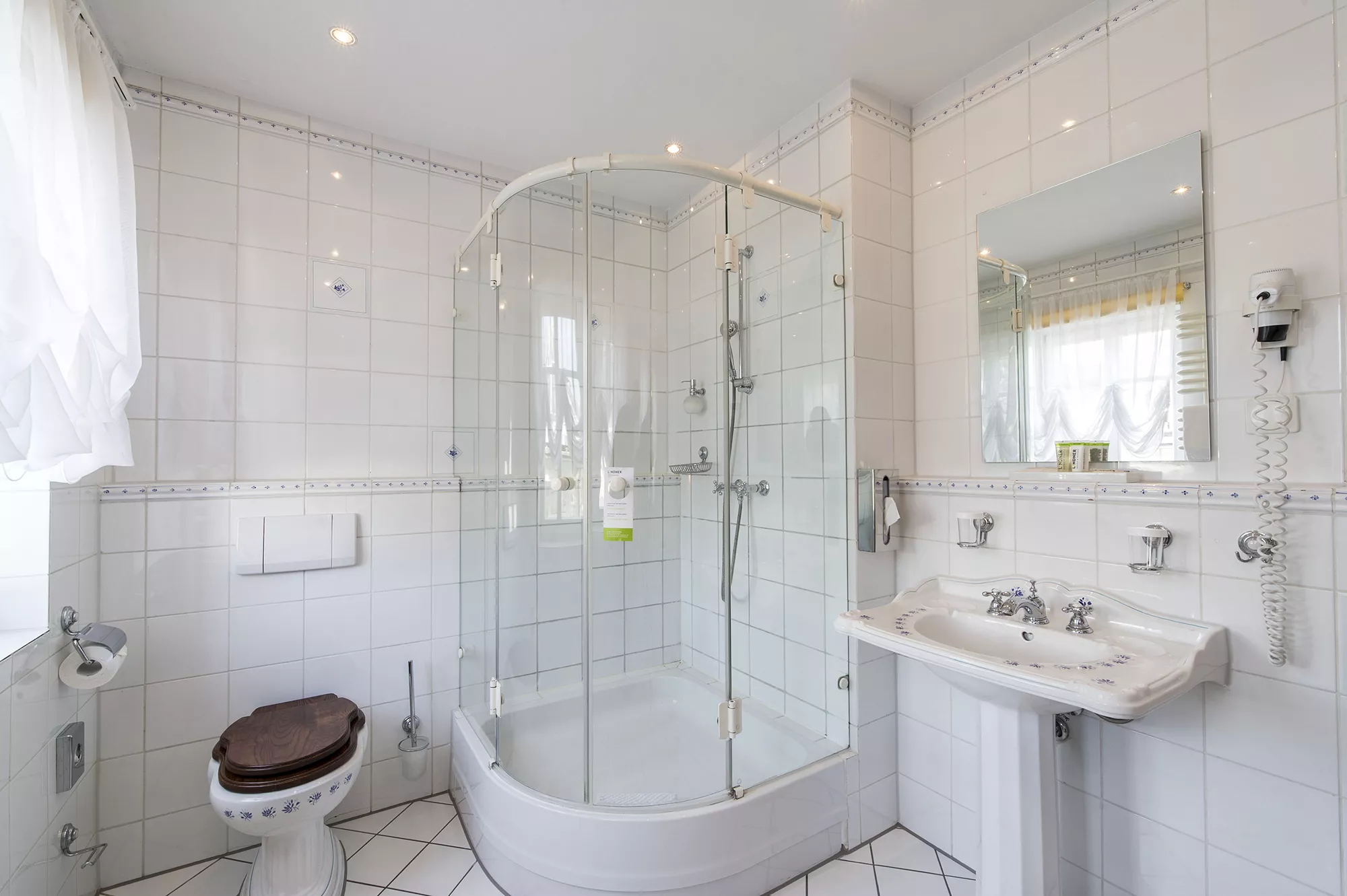 Großzügig eingerichtetes Gästebad im Lindner Hotel & Resort in Binshof in hellen Farben und moderner Badeinrichtung