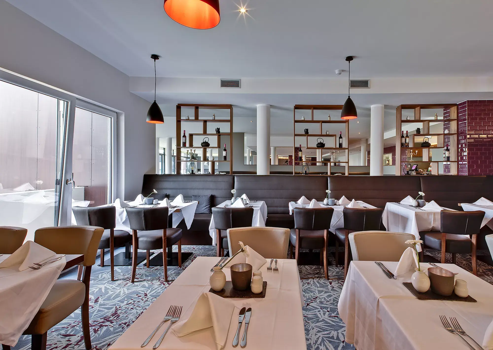 elegantes Restaurant mit braunen Lederbänken und Lederstühlen im Sante Royale Hotel Bad Langensalza