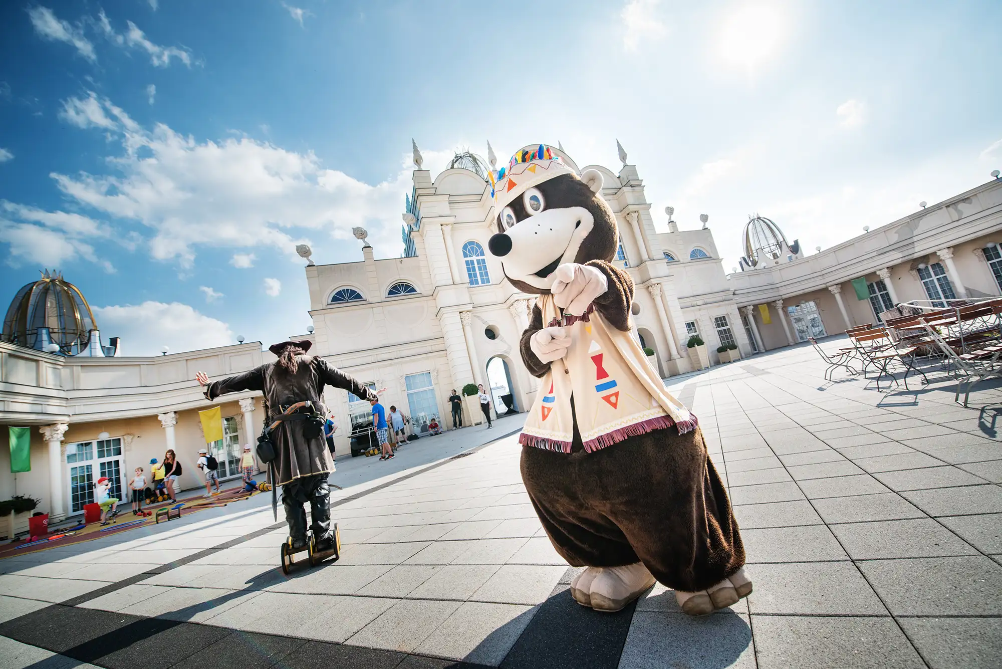 Belantis Leipzig - Maskottchen Maulwurf Buddel vor dem Schloss Belantis mit einem Piraten im Hintergrund und weiteren Menschen