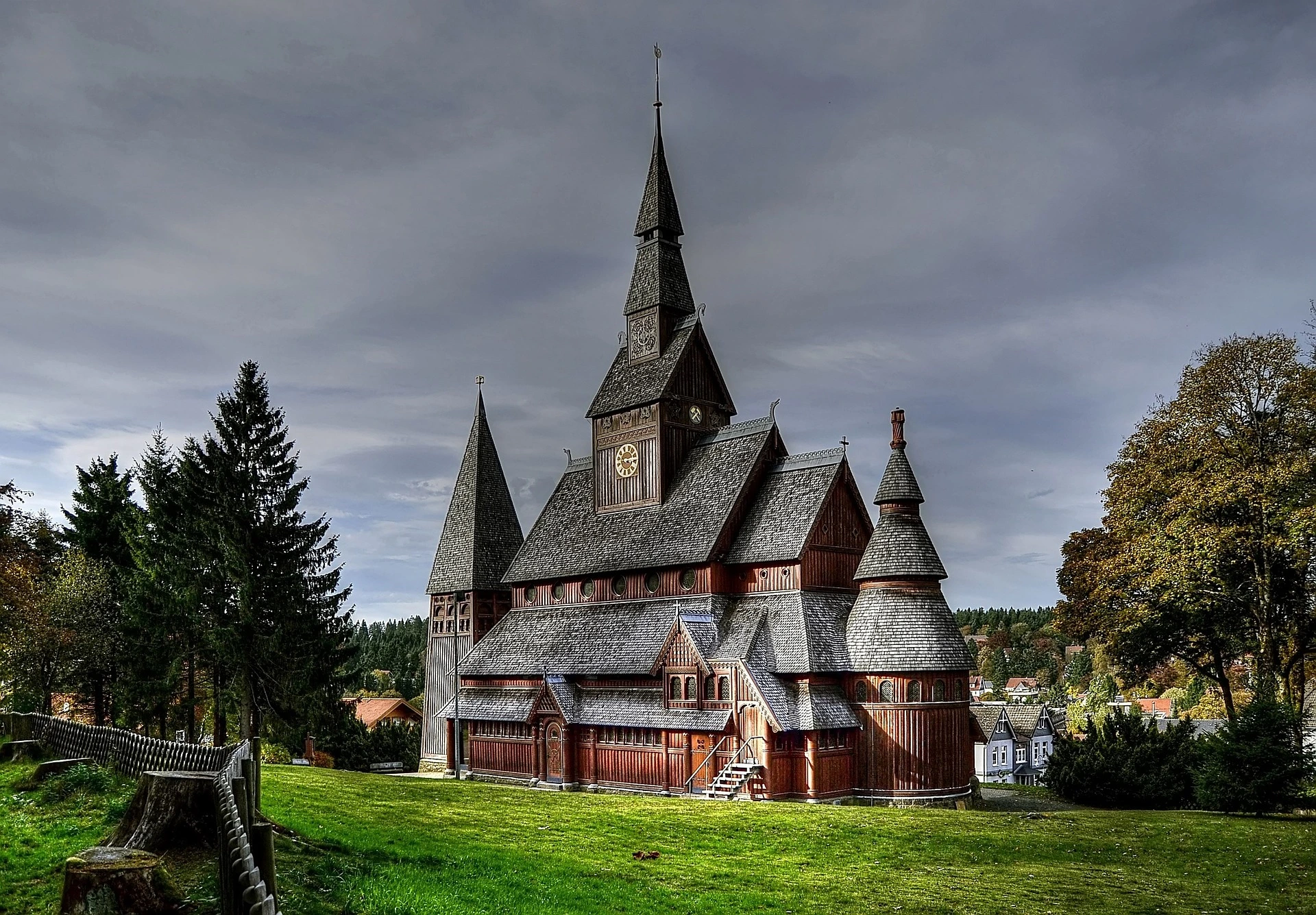 Kirche im Harz vor stark bewölktem Himmel.