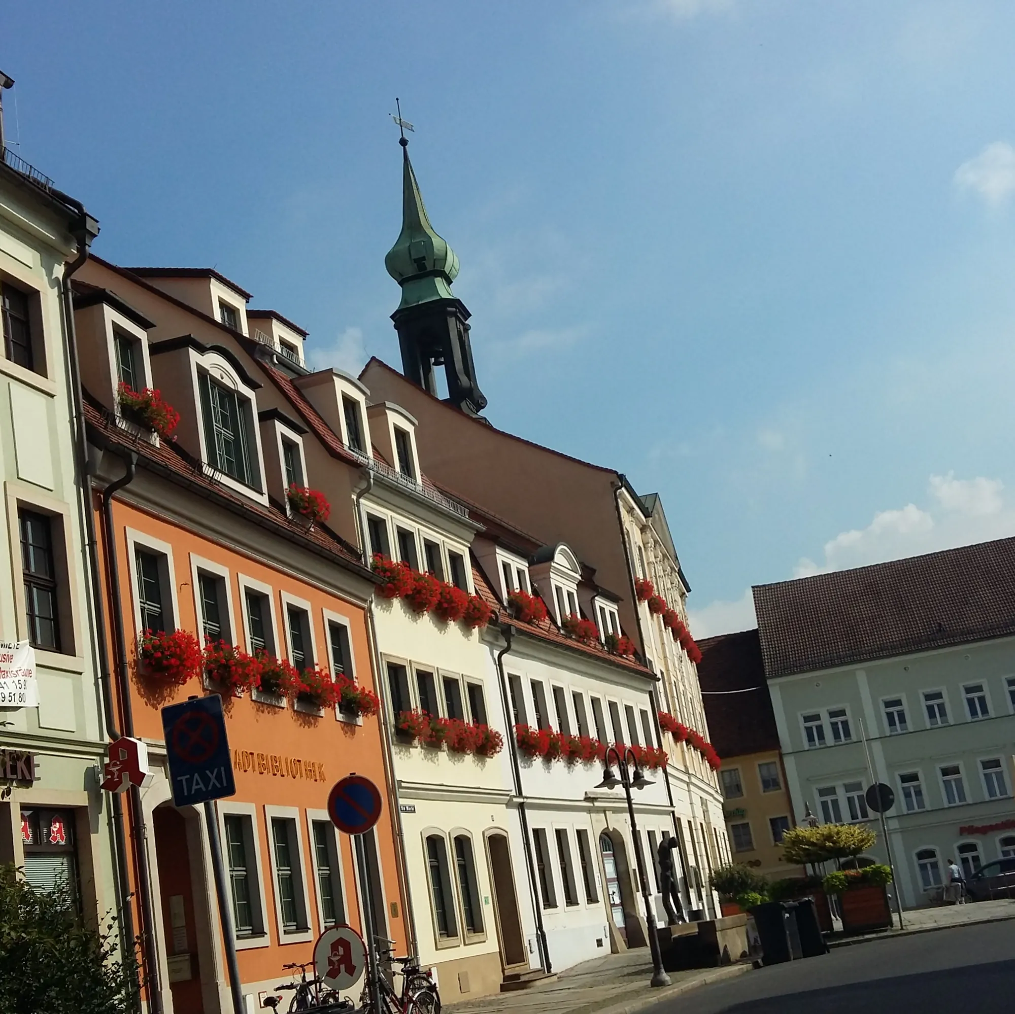 Blick auf die bunten Häuser mit Geranien am Markt in der Altstadt von Radeberg beim Kurzurlaub Sachsen