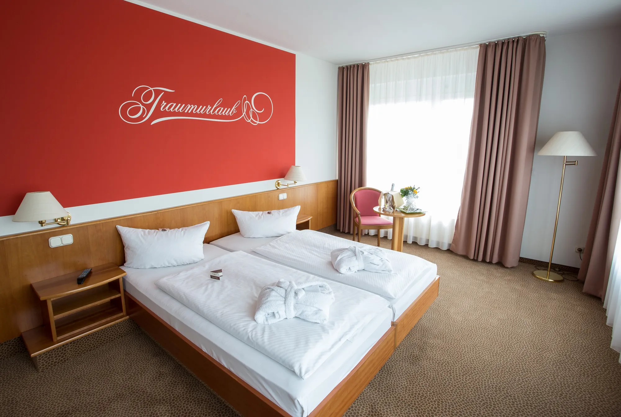 Doppelzimmer mit einer roten Wand mit der Aufschrift 